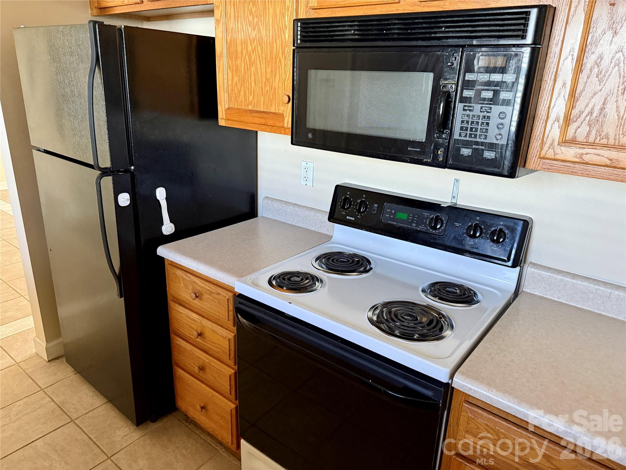 703 Olde Covington Way Arden, NC 28704 - Photo 10 of 23 a kitchen with a stove and a microwave