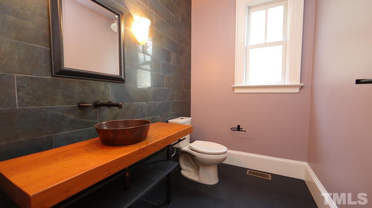 2308 Byrd Street Raleigh, NC 27608 - Photo 14 of 30 Half bath with slate stone flooring situated between the Study and Kitchen.