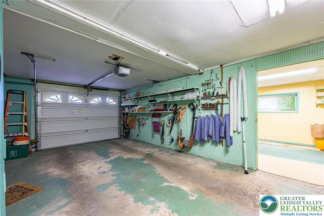 678 Interchange Road Kresgeville, PA 18333 - Photo 35 of 45 Functional garage with ample space for tools and direct access to an adjacent room.