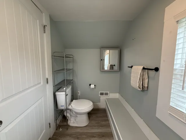 a white toilet sitting next to a bathroom sink
