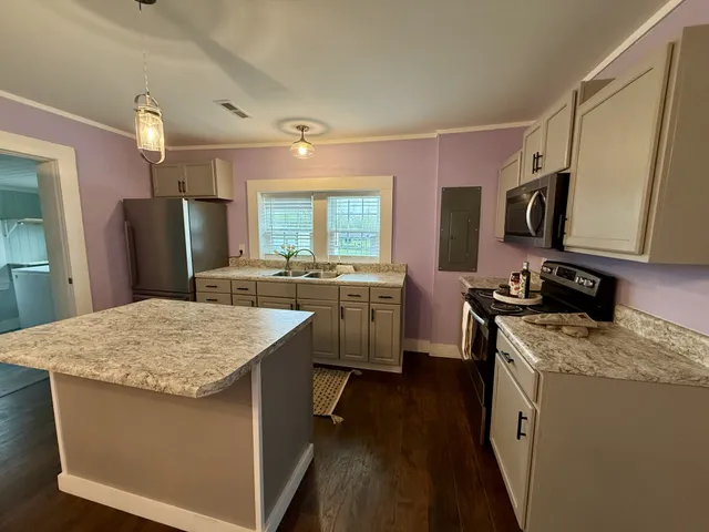 a kitchen with a sink stove and refrigerator
