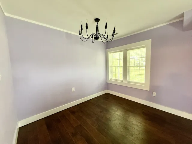 a view of room with window and hardwood floor