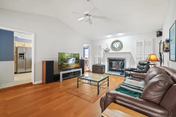 a kitchen with granite countertop stainless steel appliances a refrigerator a table and chairs