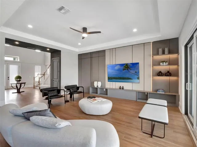a kitchen with a dining table chairs and wooden floor