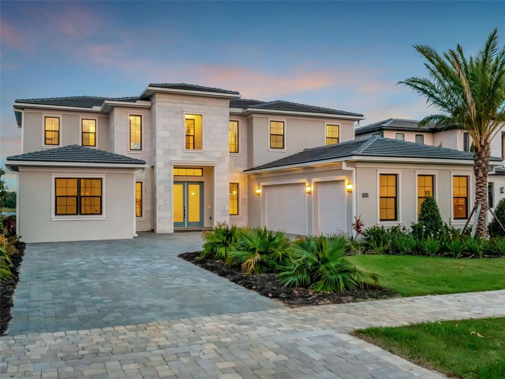 16808 Bolsena Drive Montverde, FL 34756 - Photo 2 of 68 a front view of a house with a garden