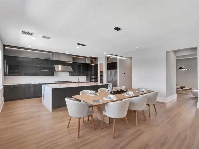 a spacious bathroom with a double vanity sink double mirror and bathtub