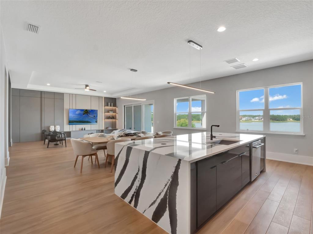 16808 Bolsena Drive Montverde, FL 34756 - Photo 30 of 68 a large kitchen with lots of counter top space a sink appliances and cabinets