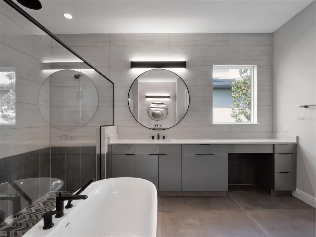 16808 Bolsena Drive Montverde, FL 34756 - Photo 40 of 68 a bathroom with a toilet a sink and mirror