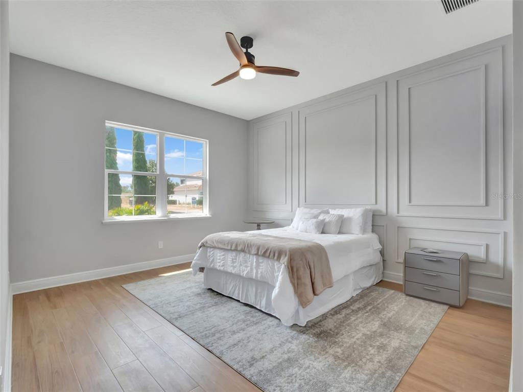 16808 Bolsena Drive Montverde, FL 34756 - Photo 42 of 68 a bed sitting in a bedroom next to a window