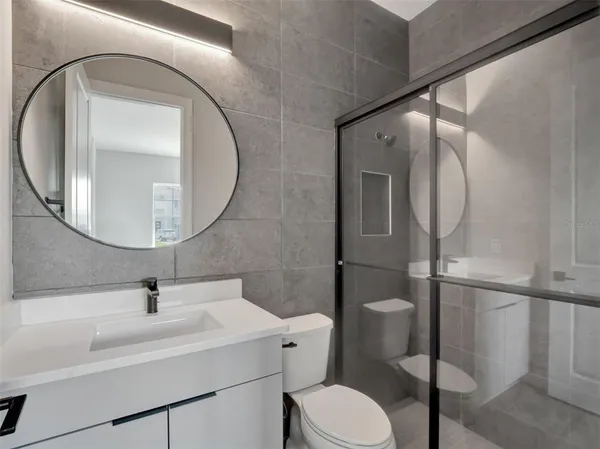 a bathroom with a sink toilet and shower