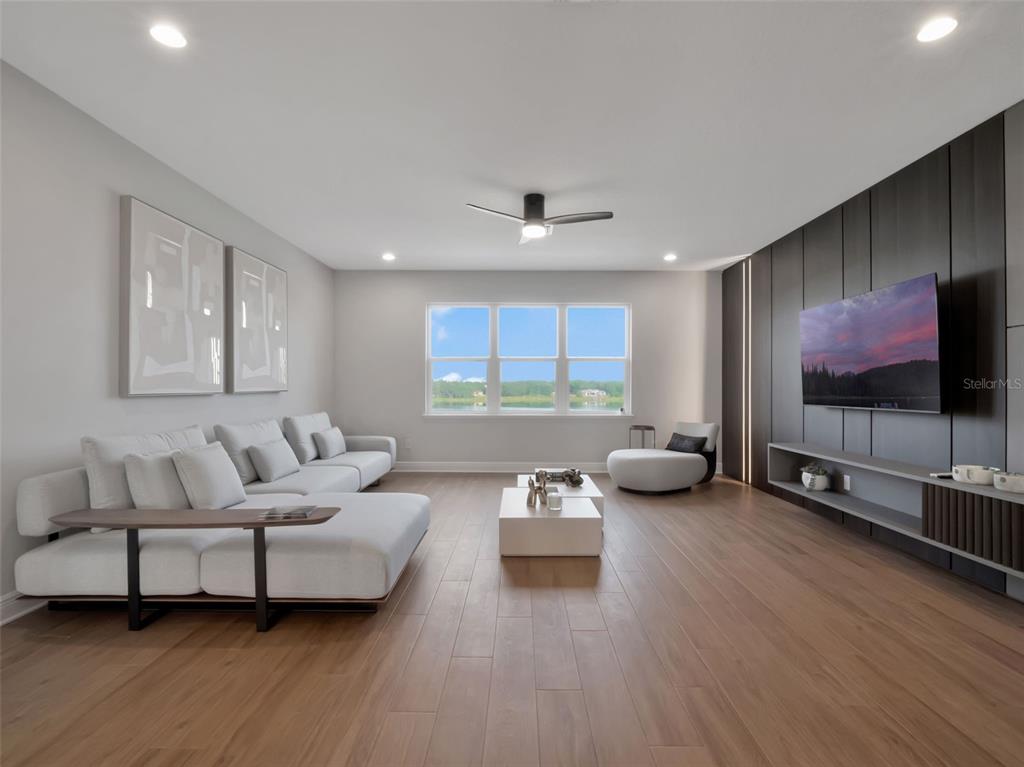 16808 Bolsena Drive Montverde, FL 34756 - Photo 45 of 68 a living room with furniture and a flat screen tv