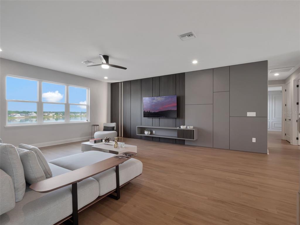 16808 Bolsena Drive Montverde, FL 34756 - Photo 46 of 68 a living room with furniture and a flat screen tv