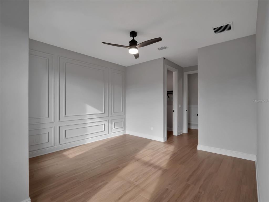 16808 Bolsena Drive Montverde, FL 34756 - Photo 50 of 68 wooden floor in an empty room with a window