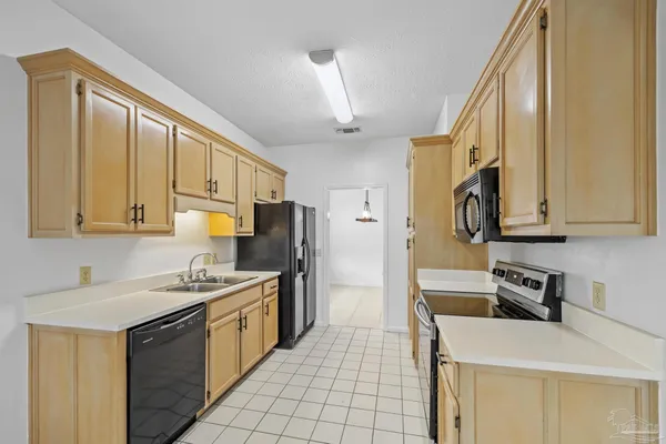 a kitchen with a sink a stove and a refrigerator