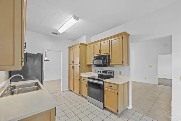 a kitchen with a sink appliances and cabinets
