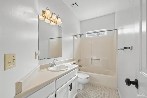 a bathroom with a granite countertop sink toilet a shower and a mirror