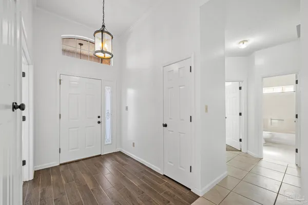 a view of a room with a white cabinet and wooden floor