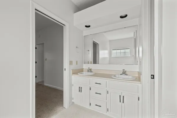 a bathroom with a granite countertop sink mirror and double