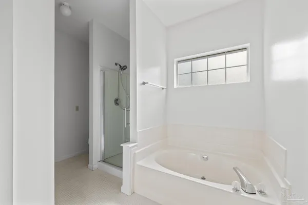 a white bath tub sitting next to a shower