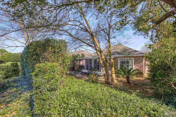 a view of a house with a tree in the yard