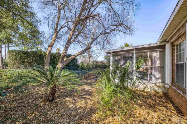 a view of a house with a tree in a yard