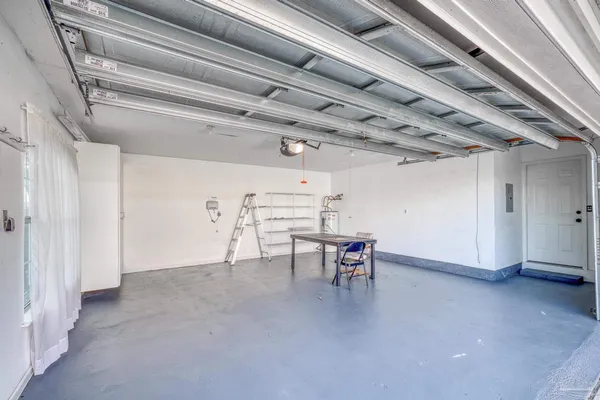a view of a room with table and chairs