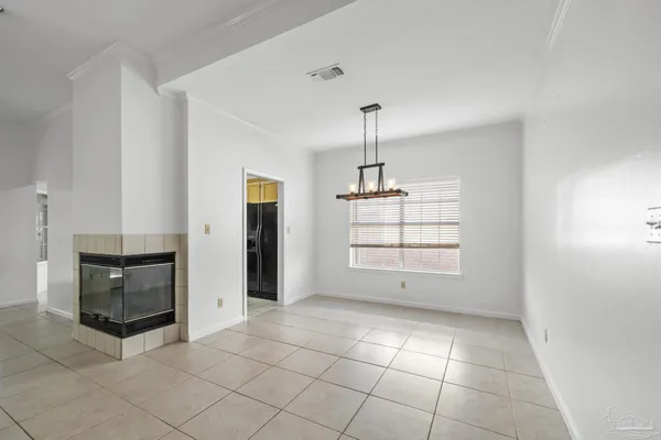a view of empty room with a fireplace and cabinet