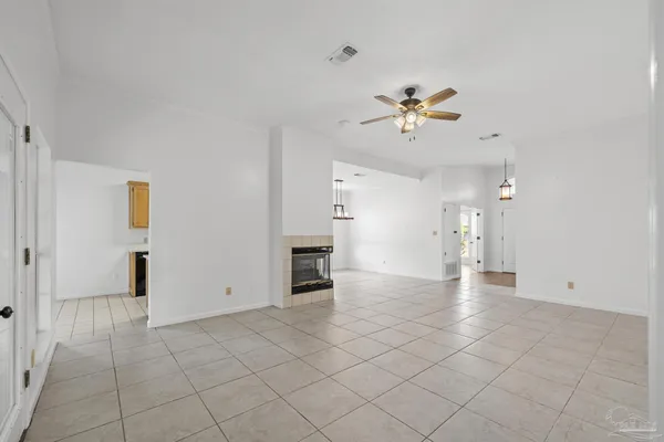 wooden floor in an empty room with a ceiling fan