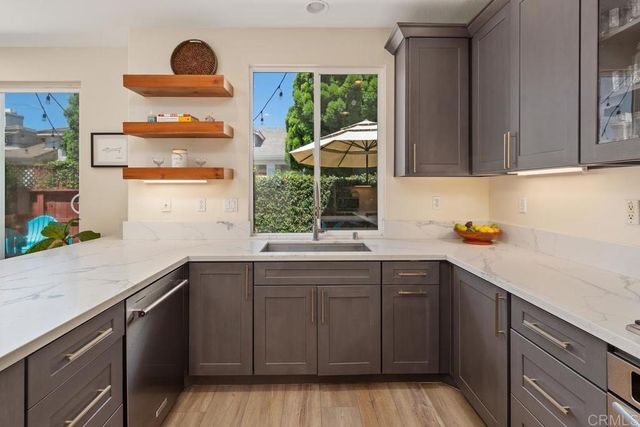 a kitchen with granite countertop a stove and a sink