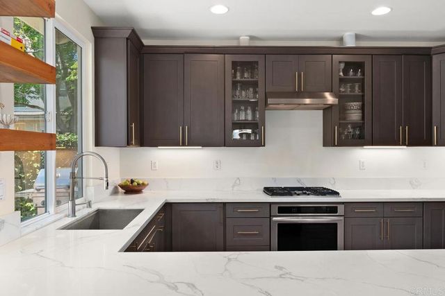 a dining room with furniture potted plants and wooden floor