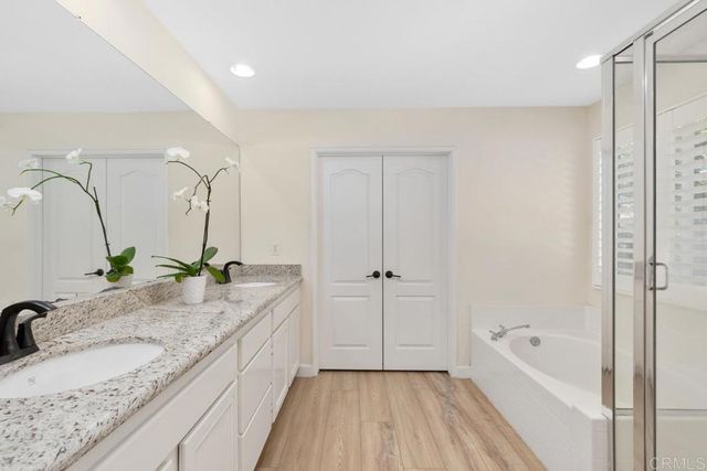 a bathroom with a double vanity sink and mirror