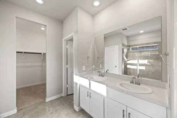 a bathroom with a double vanity sink mirror and double