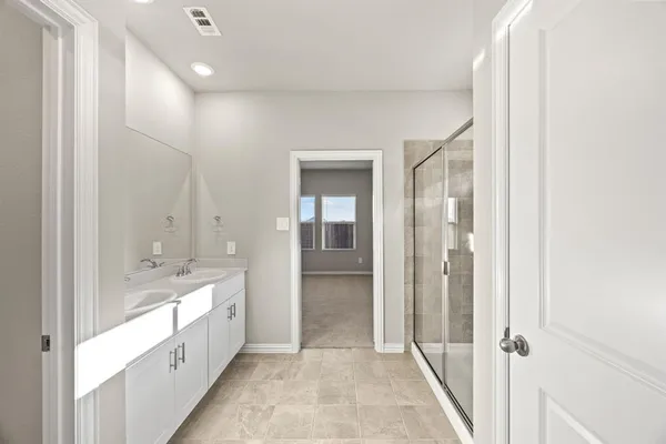 a bathroom with a double vanity sink and mirror