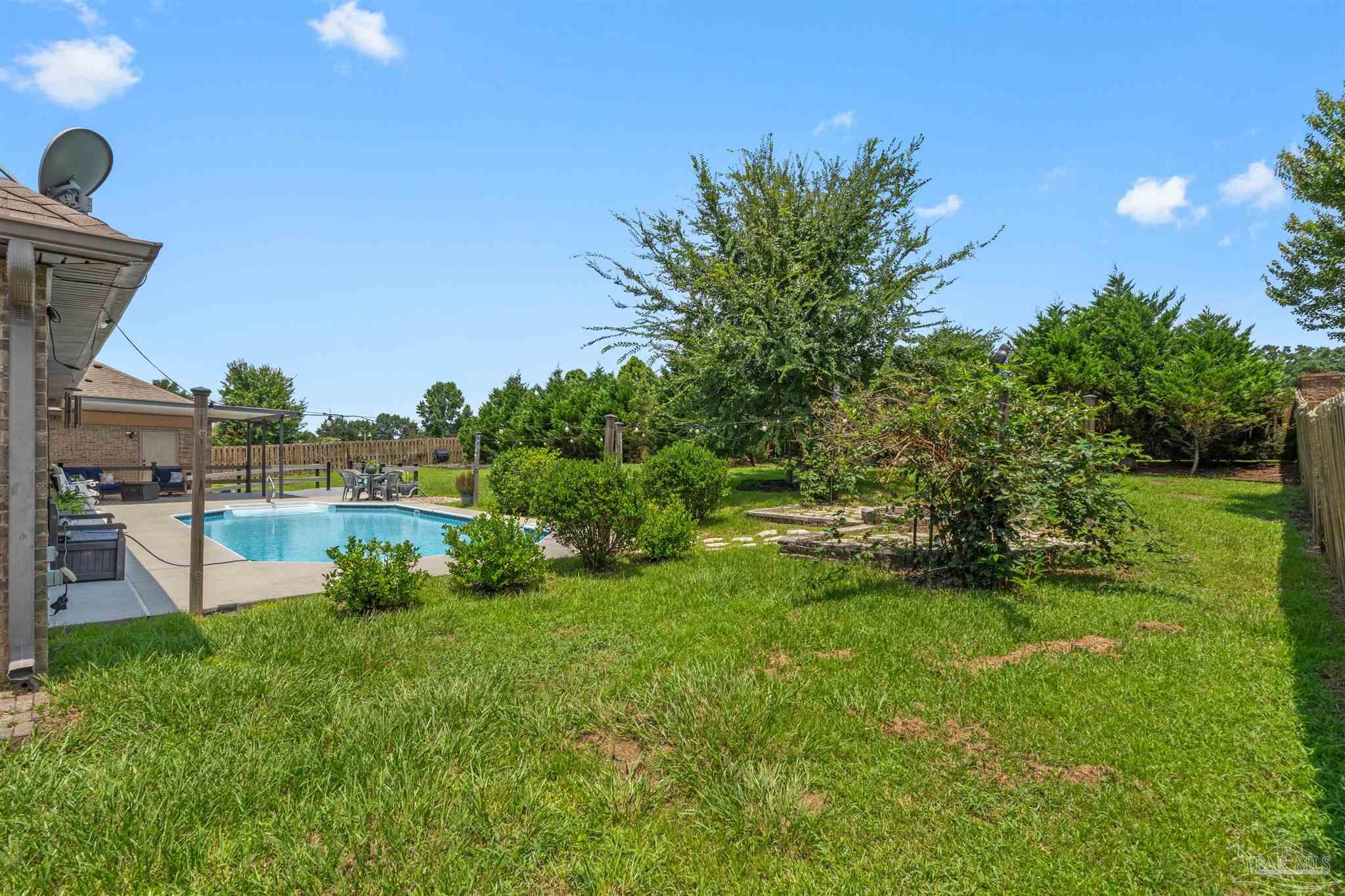 2698 Tulip Hill Road Pace, FL 32571 - Photo 63 of 65 a view of a garden with a lake
