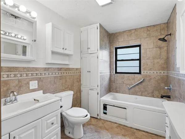 a bathroom with a toilet a sink and bathtub