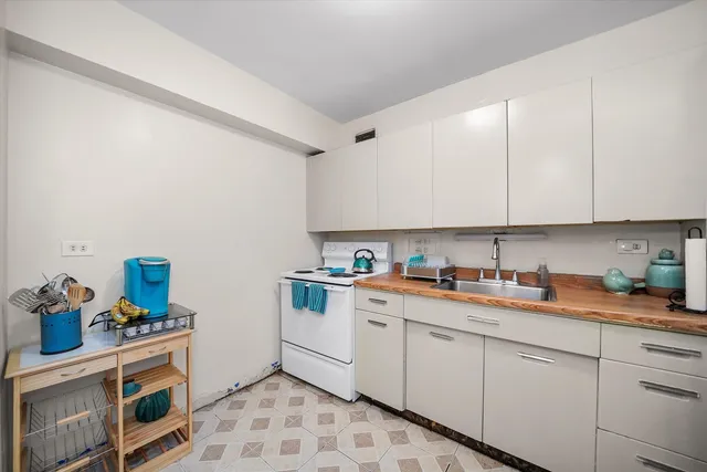 a kitchen with stainless steel appliances granite countertop a sink and a stove