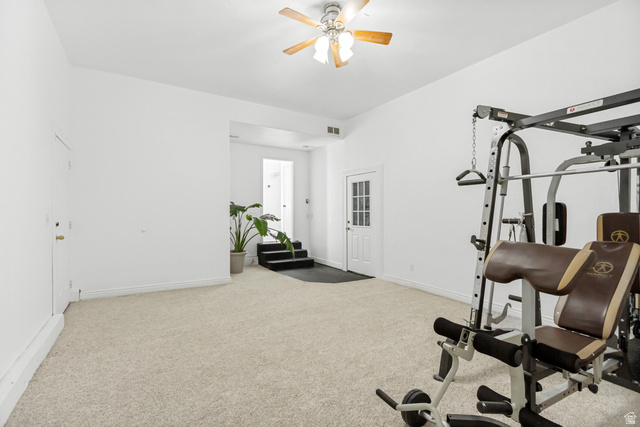 1585 South 910 West Payson, UT 84651 - Photo 13 of 32 Spacious room featuring vaulted ceilings, light-toned carpeting, a ceiling fan, and a white paneled door with glass inserts