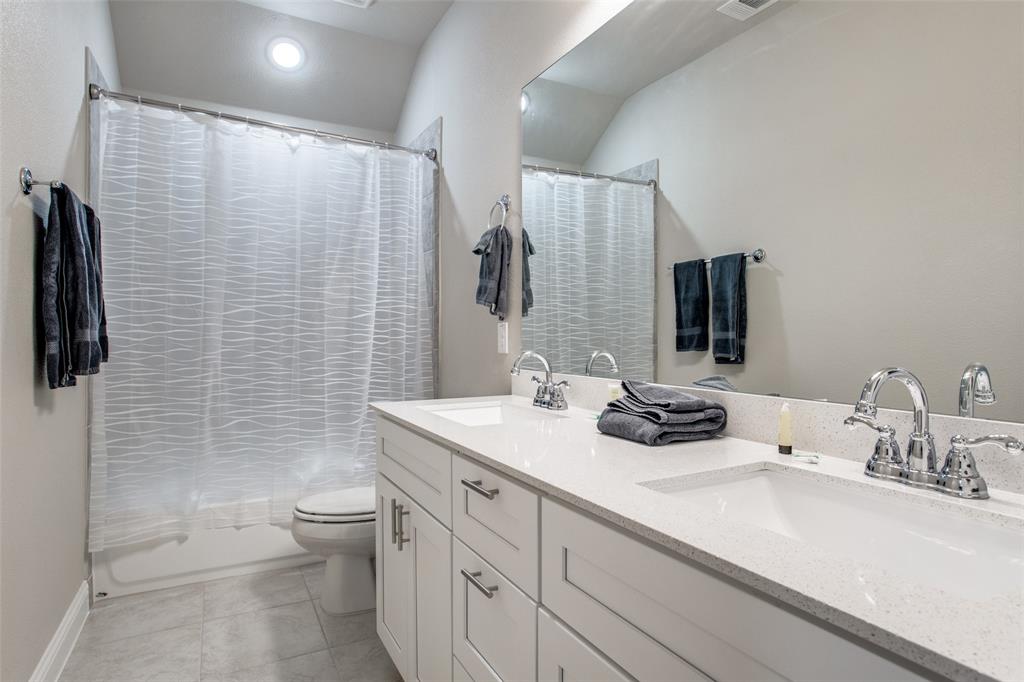 1718 Lisa Court Allen, TX 75002 - Photo 24 of 26 a bathroom with a sink a toilet and shower