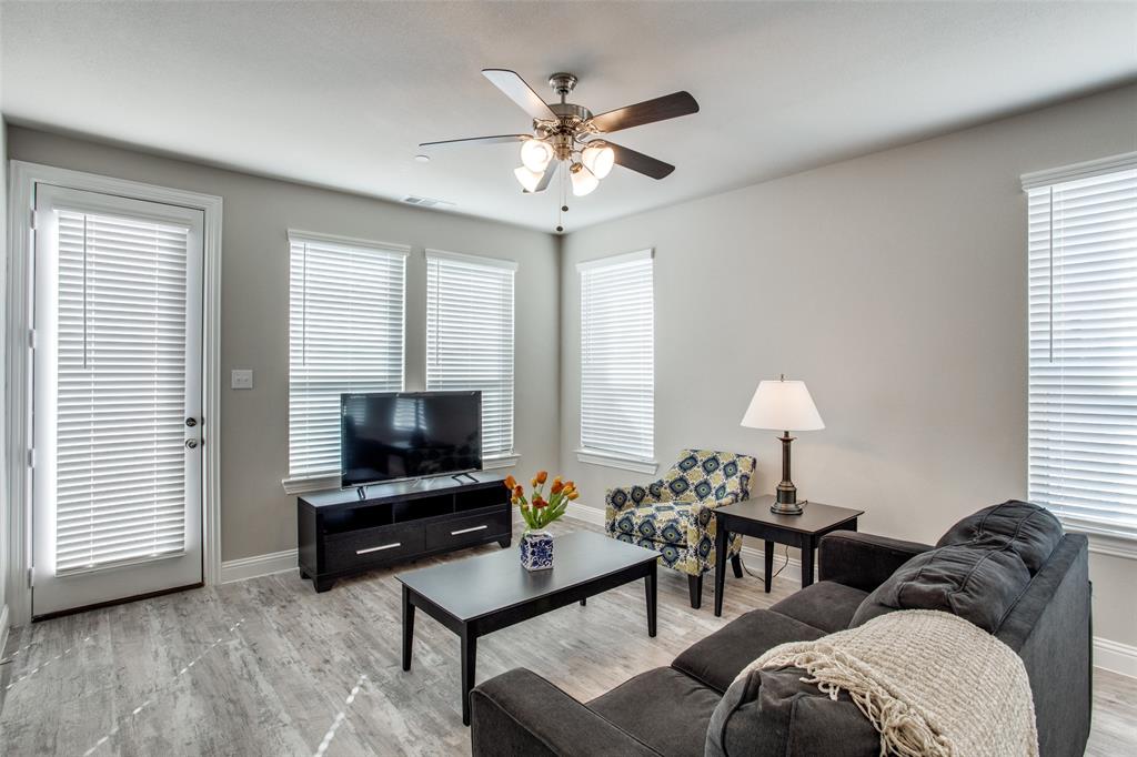 1718 Lisa Court Allen, TX 75002 - Photo 4 of 26 a living room with furniture a chandelier and a flat screen tv