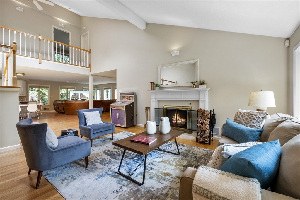 a living room with furniture a fireplace and a table