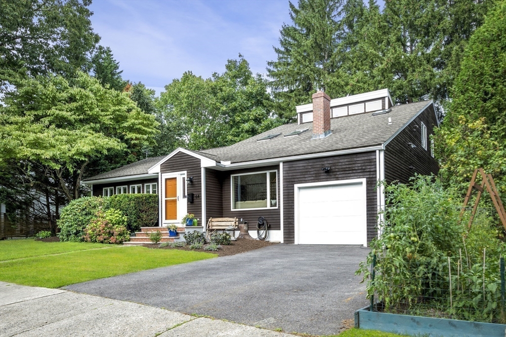64 Botsford Road Newton, MA 02467 - Photo 2 of 6 a front view of a house with a yard and garage