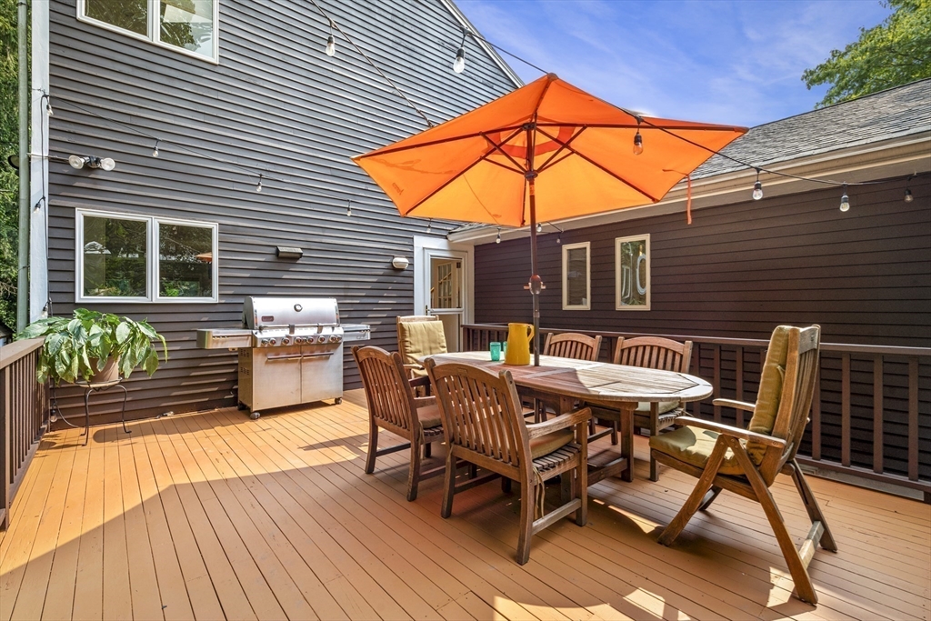 64 Botsford Road Newton, MA 02467 - Photo 4 of 6 a view of a chairs and table on the deck