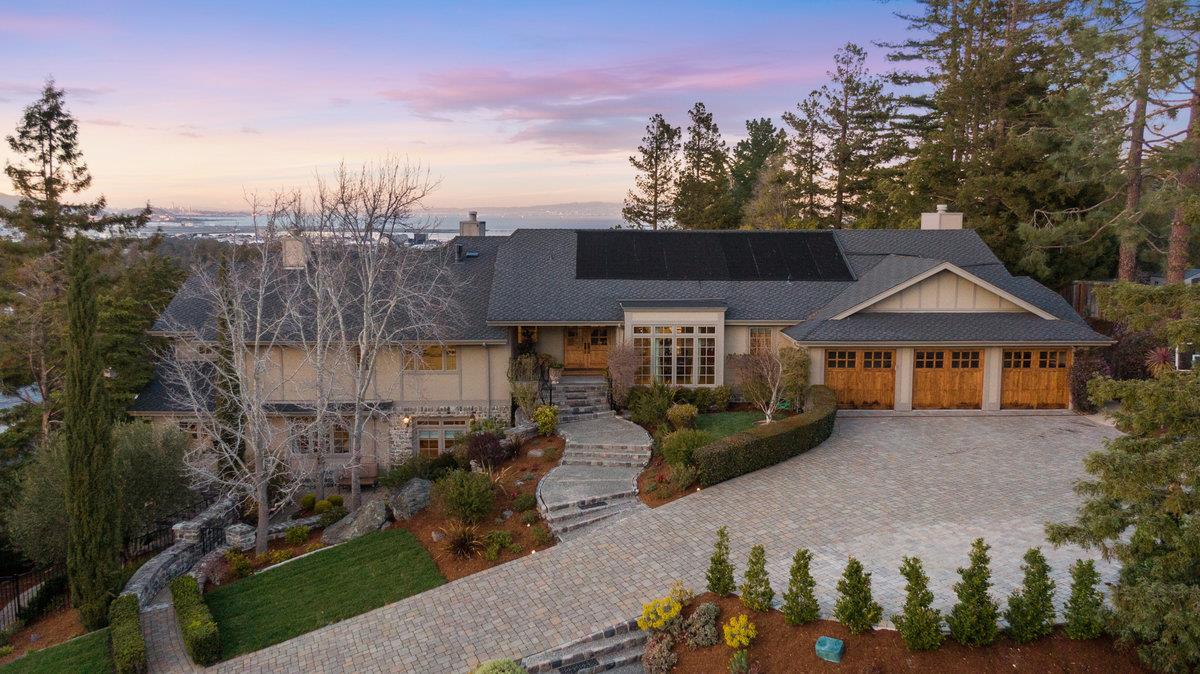a front view of a house with a yard and potted plants