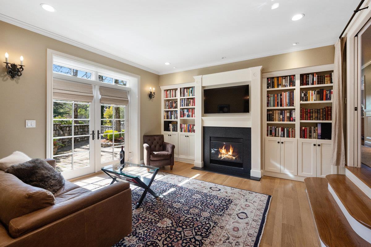 714 Jacaranda Circle Hillsborough, CA 94010 - Photo 23 of 57 a living room with furniture a flat screen tv and a fireplace