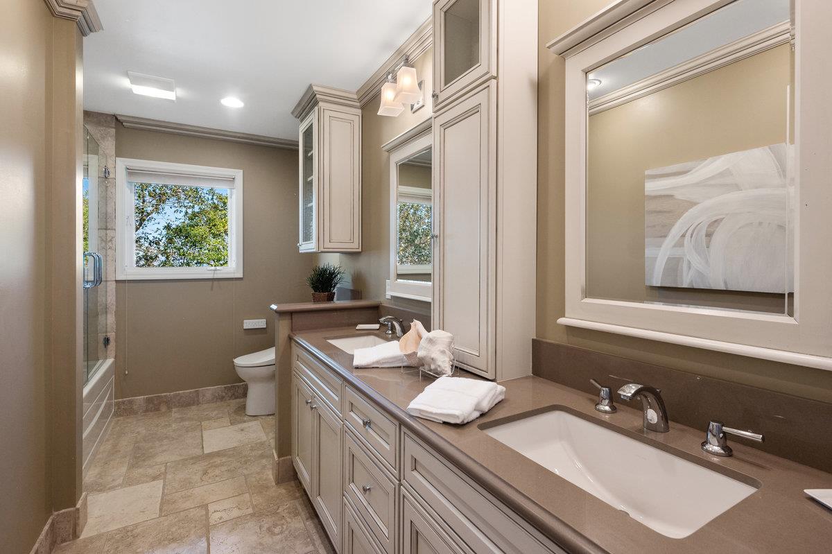714 Jacaranda Circle Hillsborough, CA 94010 - Photo 25 of 57 a bathroom with a double vanity sink toilet and a mirror