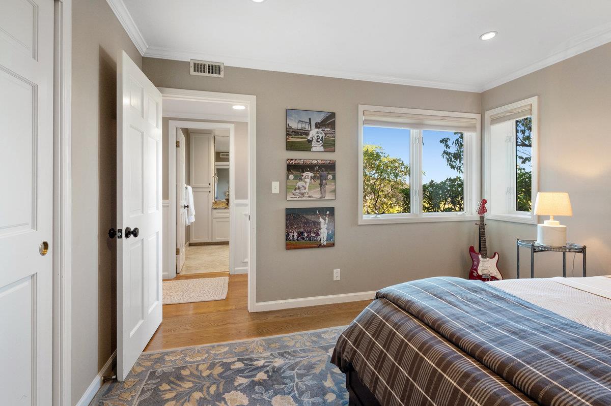 714 Jacaranda Circle Hillsborough, CA 94010 - Photo 31 of 57 a bedroom with a bed and a painting on the wall