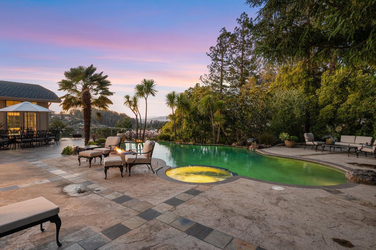 714 Jacaranda Circle Hillsborough, CA 94010 - Photo 43 of 57 a backyard of a house with table and chairs
