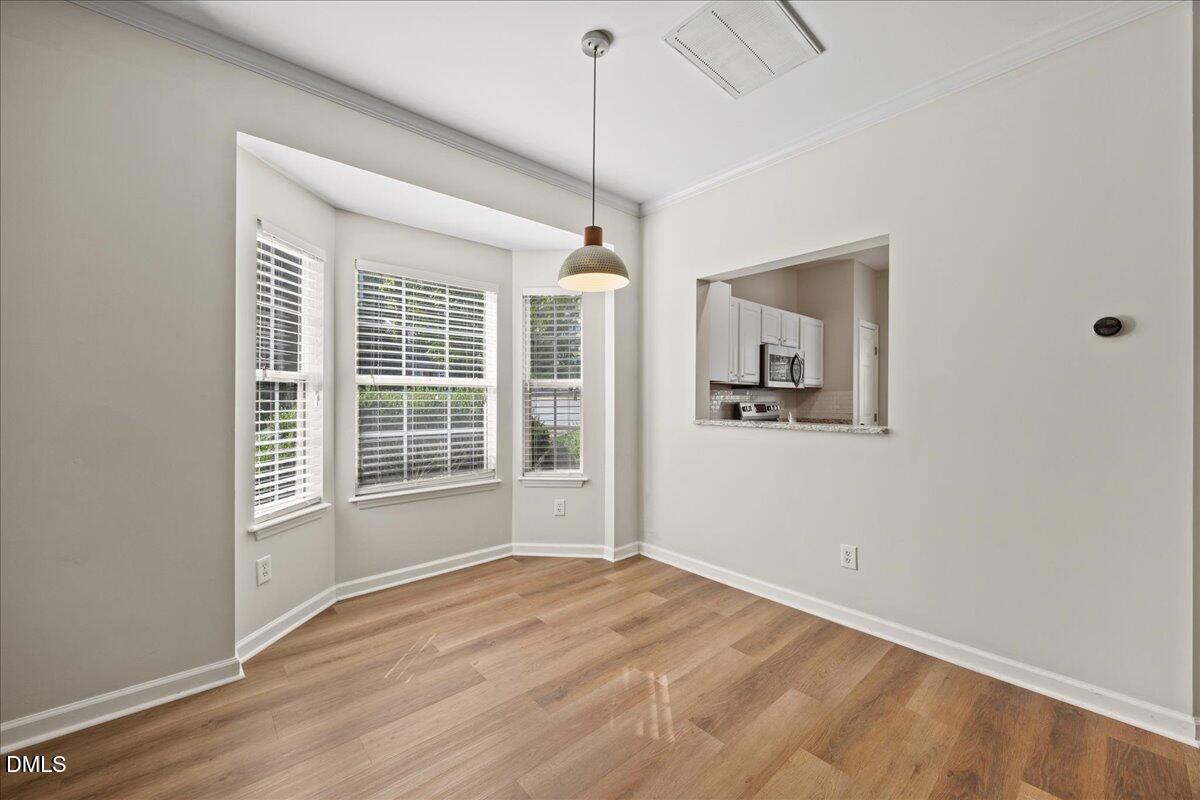 4329 Pine Springs Court Raleigh, NC 27613 - Photo 12 of 35 a view of empty room with wooden floor and fan