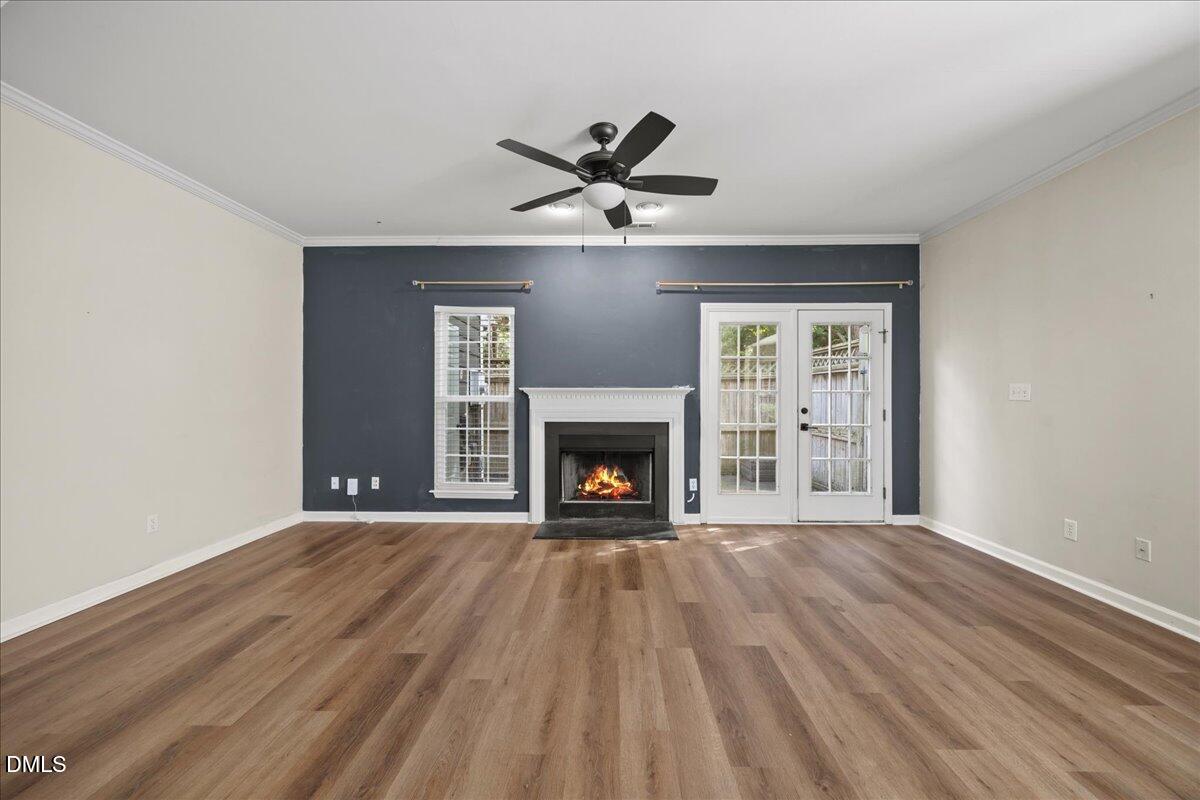 4329 Pine Springs Court Raleigh, NC 27613 - Photo 15 of 35 a view of an empty room with a fireplace and a window