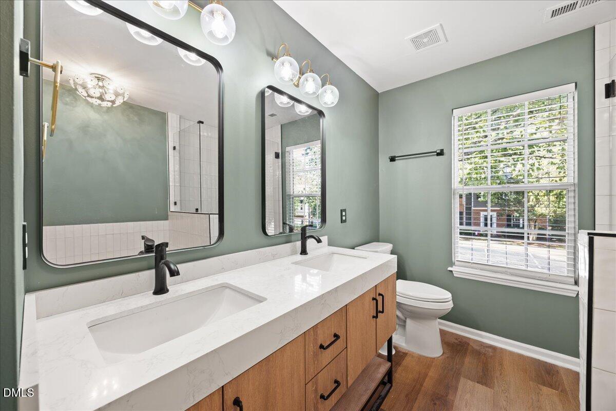 4329 Pine Springs Court Raleigh, NC 27613 - Photo 20 of 35 a bathroom with a sink a toilet and a mirror
